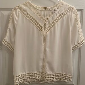 Medium white/cream colored top. Zipper in the back.